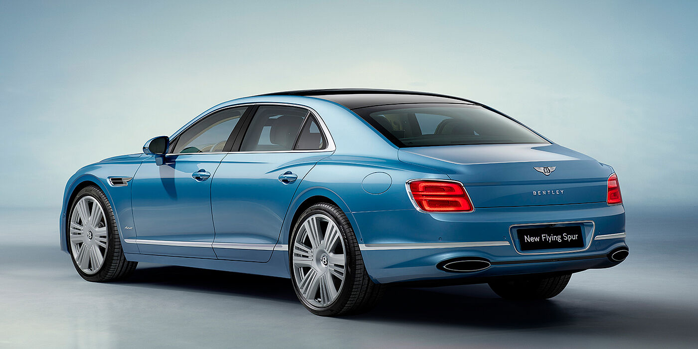 Bentley Leicester New Bentley Flying Spur Azure sedan rear view in Light windsor blue by Mulliner paint with 22 inch Azure wheels and chrome exterior details