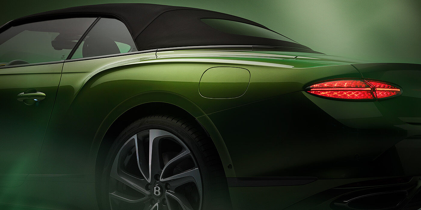 Bentley Leicester Bentley New Continental GTC Speed rear haunch and tail lamp in Tourmaline Green paint and dark tint brightware with black hood up and illuminated head lamps