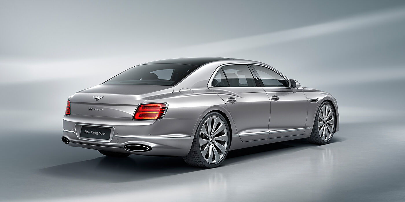 Bentley Leicester New Bentley Flying Spur sedan rear view in Silverlake paint with ten spoke wheels and chrome matrix grille