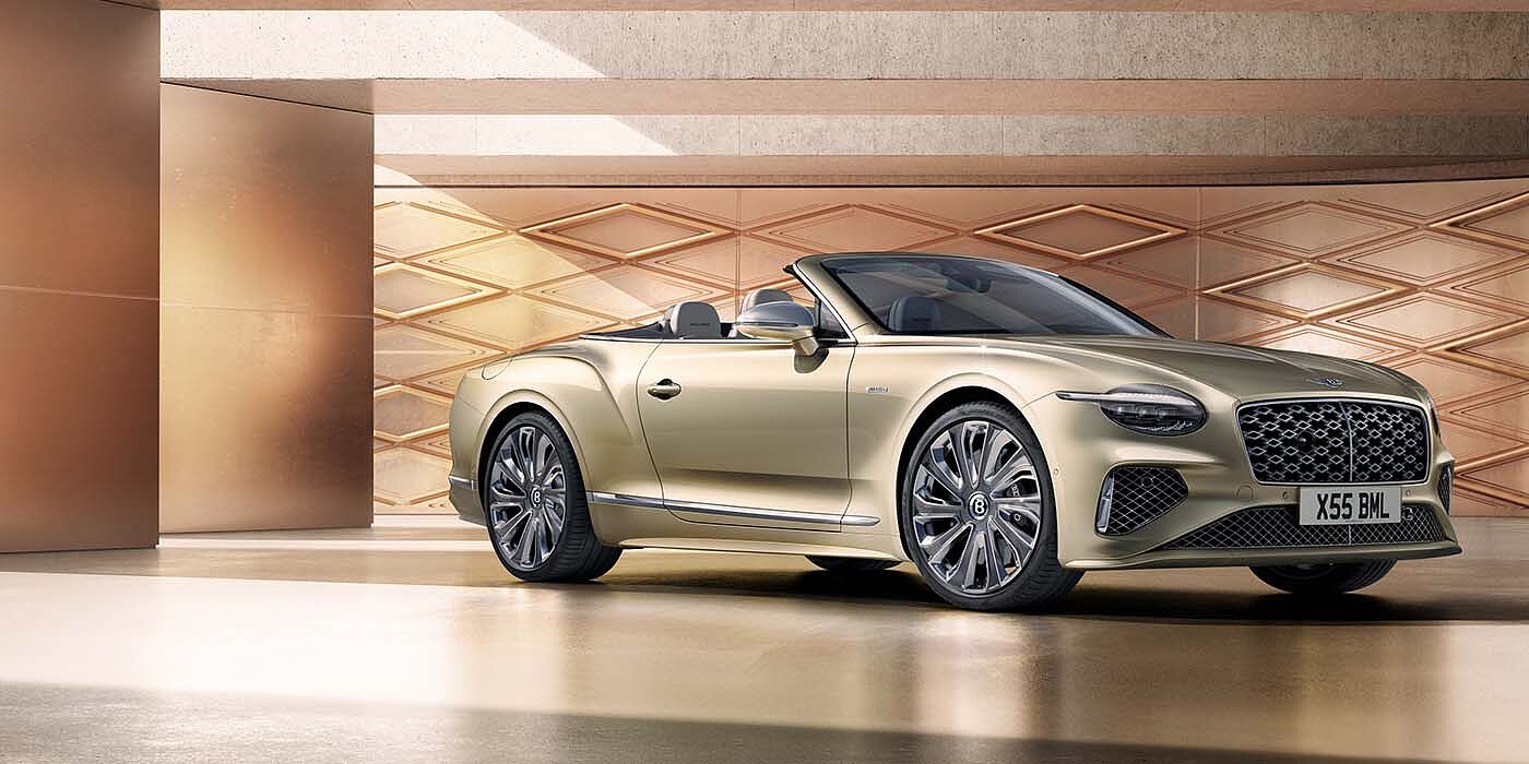Bentley Leicester Bentley New Continental GTC Mulliner V8 hybrid front three quarters in Patina paint