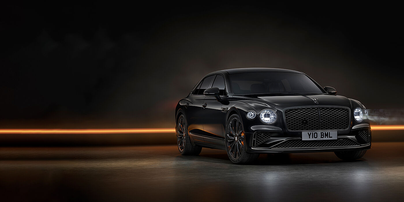 Bentley Leicester Bentley Flying Spur Black Edition sedan in Black Crystal paint against a dark grey and copper coloured background