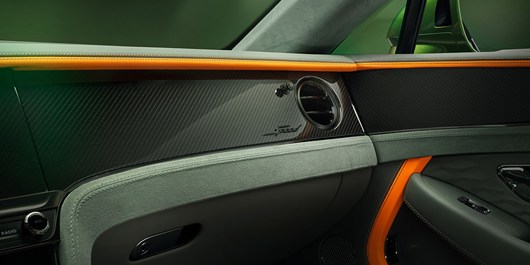 Bentley Leicester Bentley Continental GT Speed coupe front interior dash detail with high gloss carbon fibre veneer surrounded by Mandarin by Mulliner and Gravity Grey hides