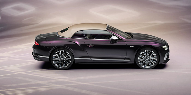 Bentley Leicester Bentley Continental GTC Mulliner convertible in profile with hood up, in Tanzanite Purple paint and 22 inch Mulliner painted and polished wheels