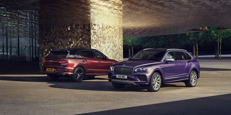 Bentley Leicester A duo of Bentley Bentayga Extended Wheelbase Mulliner SUVs parked in a city environment, with Tanzanite Purple and Cricket Ball red exterior paint