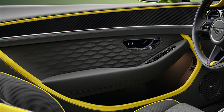 Bentley Leicester Bentley Continental GTC Speed convertible interior door details featuring Gravity Grey and Cyber Yellow by Mulliner hides and high gloss carbon fibre veneer