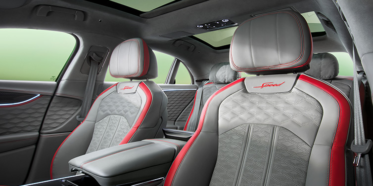 Bentley Leicester Bentley Flying Spur Speed sedan interior showing front and rear seats in Hotspur red and Gravity Grey hides, with Speed seat emblems