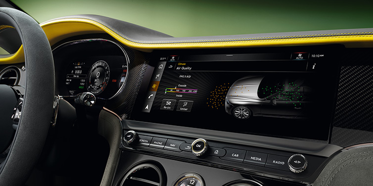 Bentley Leicester Bentley Continental GTC Speed convertible front interior centre console with MMI screen showing Air Quality visualisation surrounded by Cyber Yellow by Mulliner and Gravity Grey hides and high gloss carbon fibre veneer